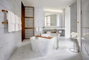 Regrouted luxury hotel bathroom with wooden details and meticulous stonework
