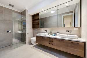 Spacious luxury bathroom with glass shower screen and ample storage