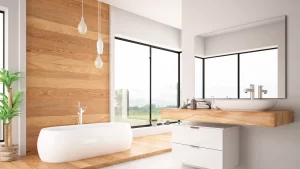 Modern minimalist bathroom with a freestanding tub, wood accents, and large windows offering natural light.