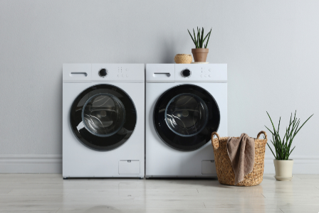 Laundry area with washing machines on a tiled floor, representing the wet area waterproofing service of SRC.