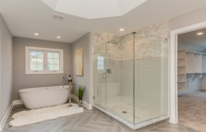 Modern bathroom with a frameless glass tiled shower and freestanding bathtub
