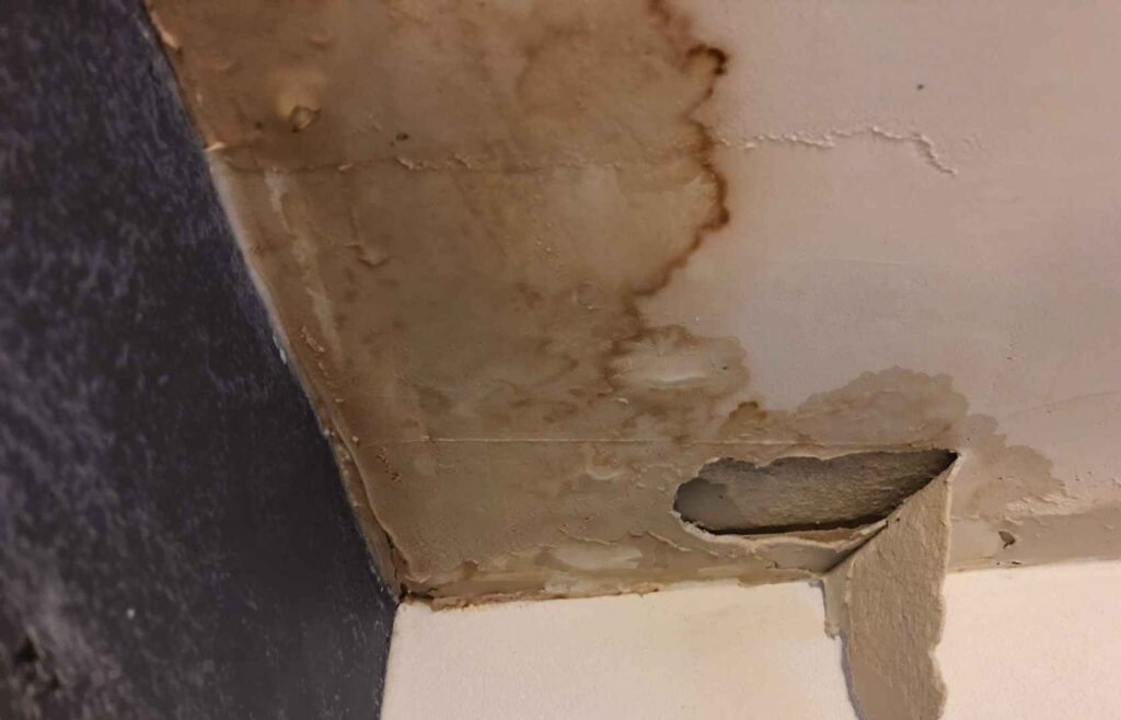 Leaking Shower this Winter? 5 Things Strata & Property Managers Should Do 1 Water-stained and damaged ceiling showing signs of moisture from a leaking shower above.